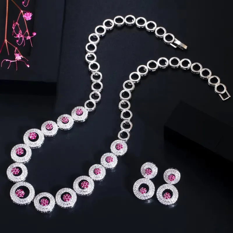 Silver-toned round zirconia necklace and earrings set with pink center stones