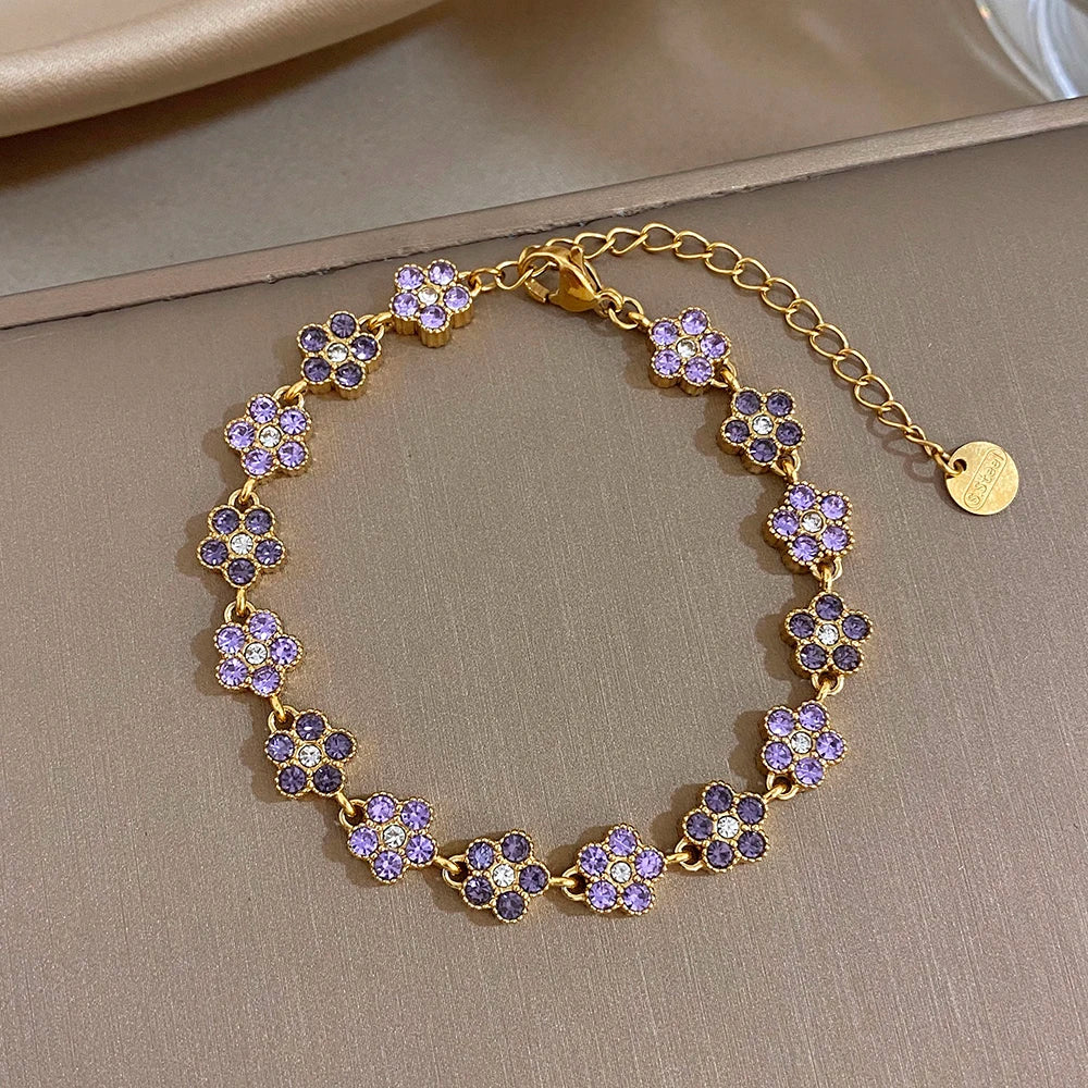 Gold-tone bracelet with purple and pink flower zircon beads on a delicate chain