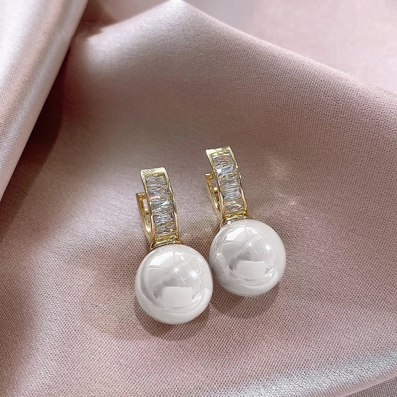 Gold-tone hoop earrings with round white imitation pearl drops