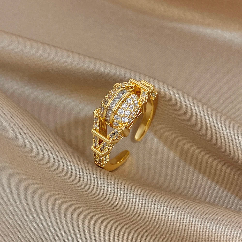 Gold-tone open geometric zircon ring with square lattice and clear crystal detailing