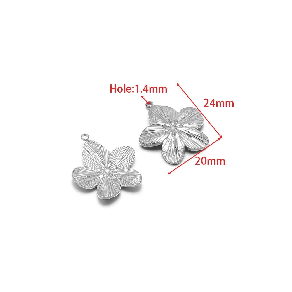 Silver floral charm pendant with embossed petals and small bail loop