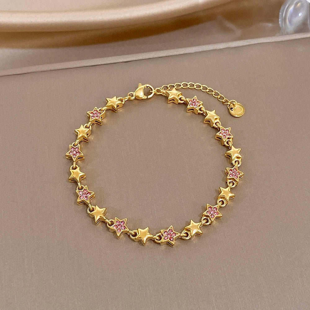 Gold-tone star charm bracelet with multicolor zircon-like inlays, round link chain