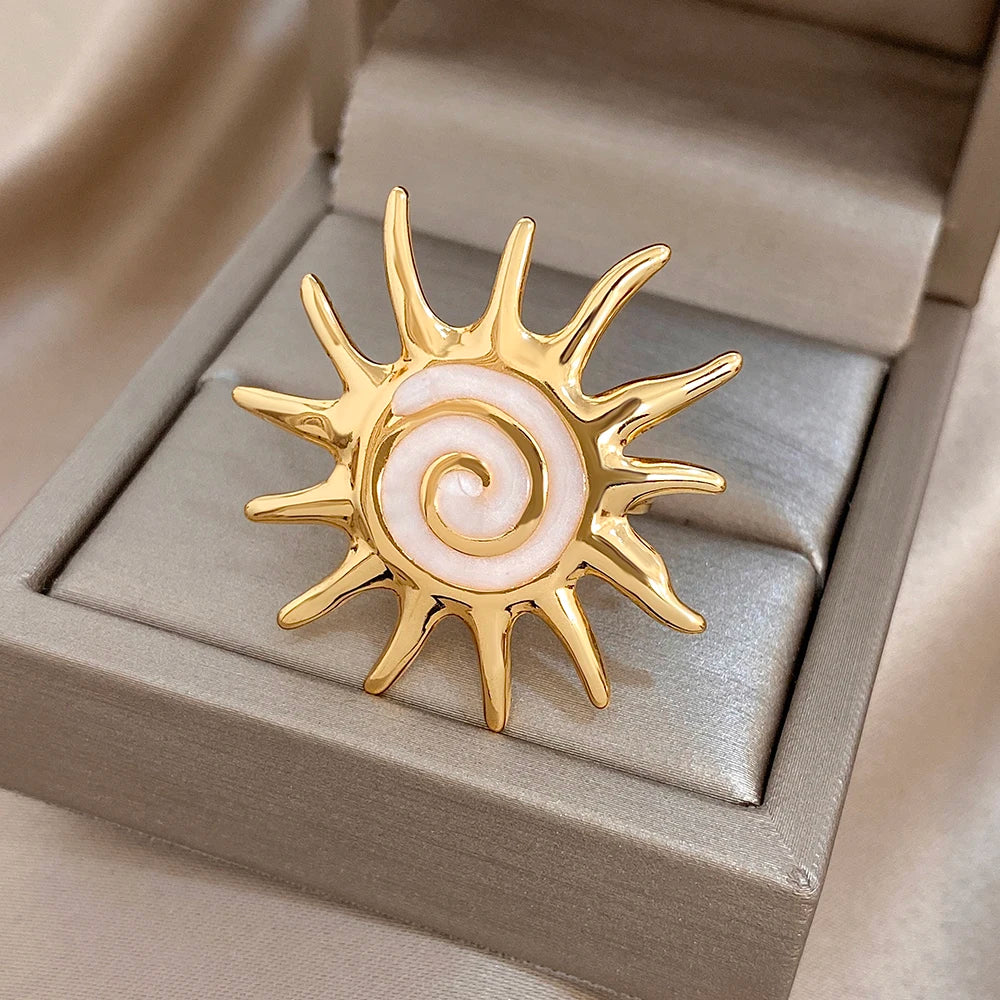 Gold-plated sunburst ring with pale lavender enamel spiral center