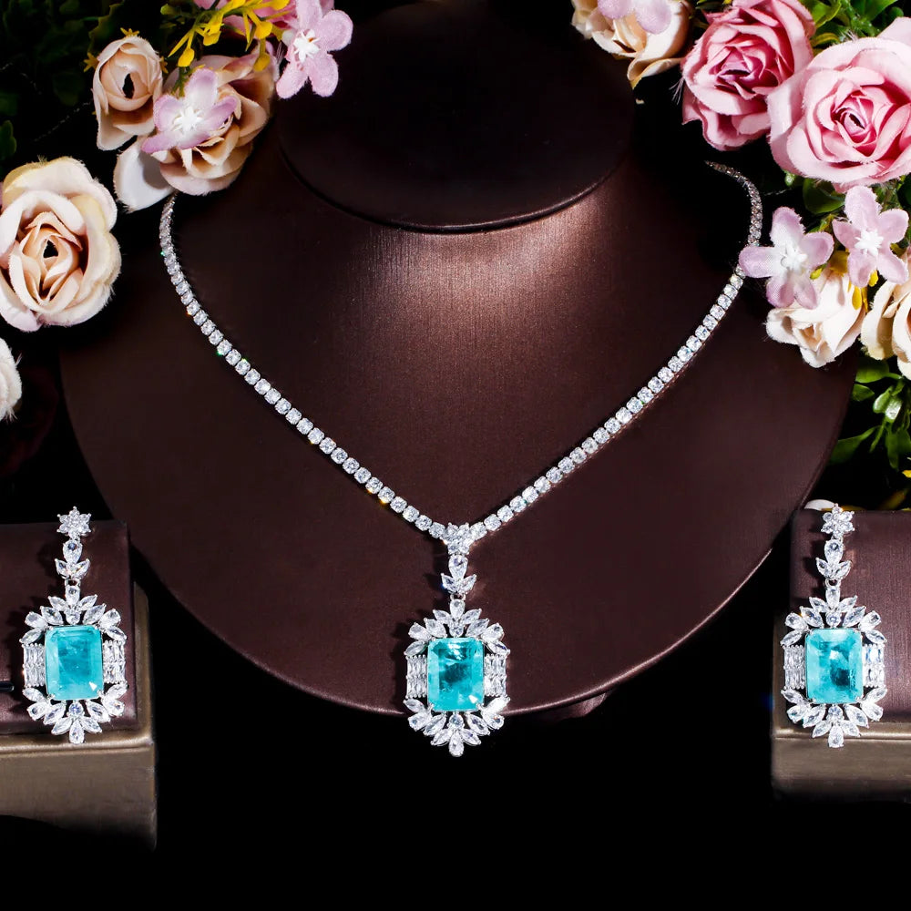 Cubic zirconia jewelry set with teal square stones, silver-tone necklace and matching earrings