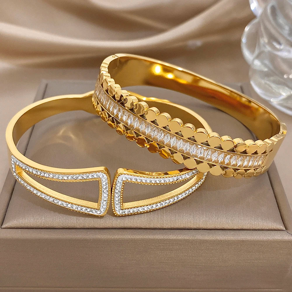 Gold-tone cuff bangle with geometric hollow design and clear rhinestone trim