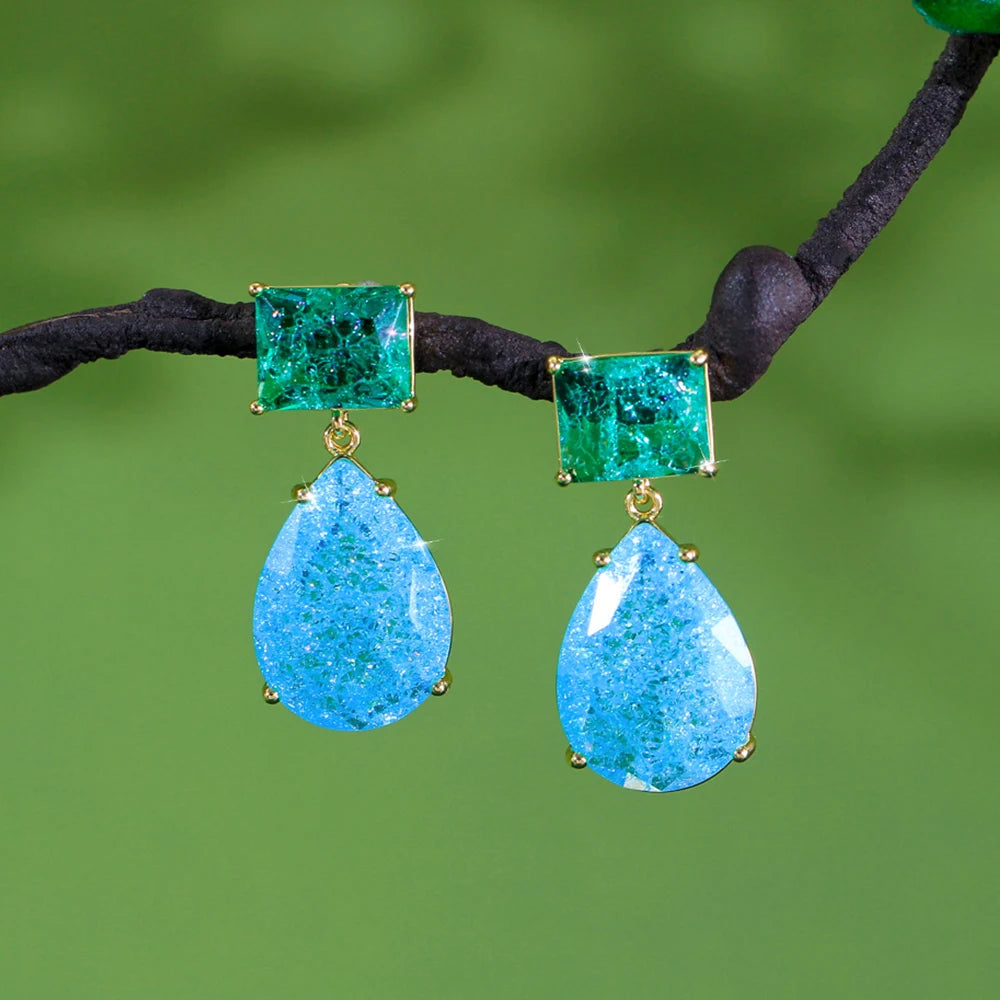 Green square and blue teardrop drop earrings with sparkling stones and gold-tone settings