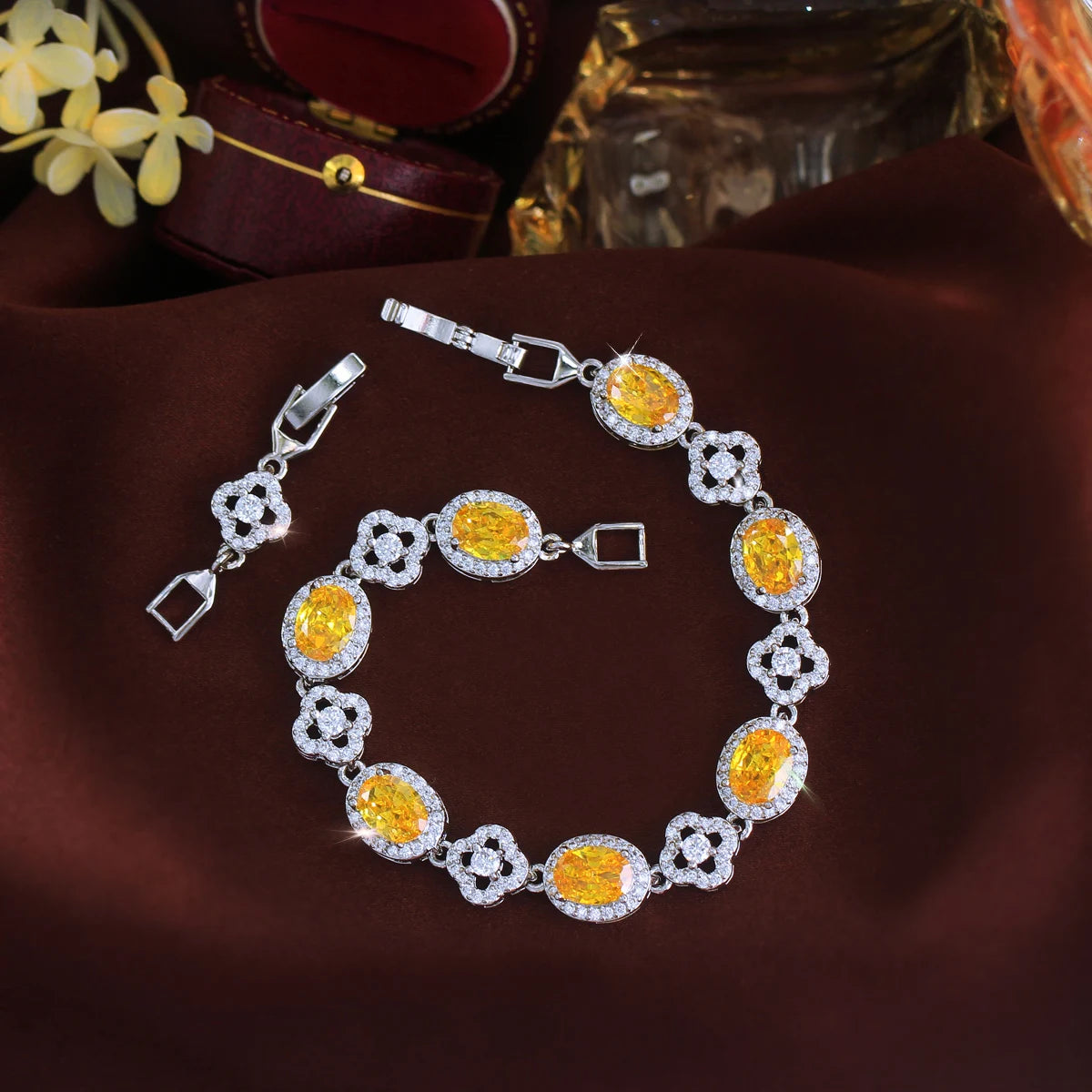 Yellow oval crystal flower tennis bracelet arranged in a circle with clasp