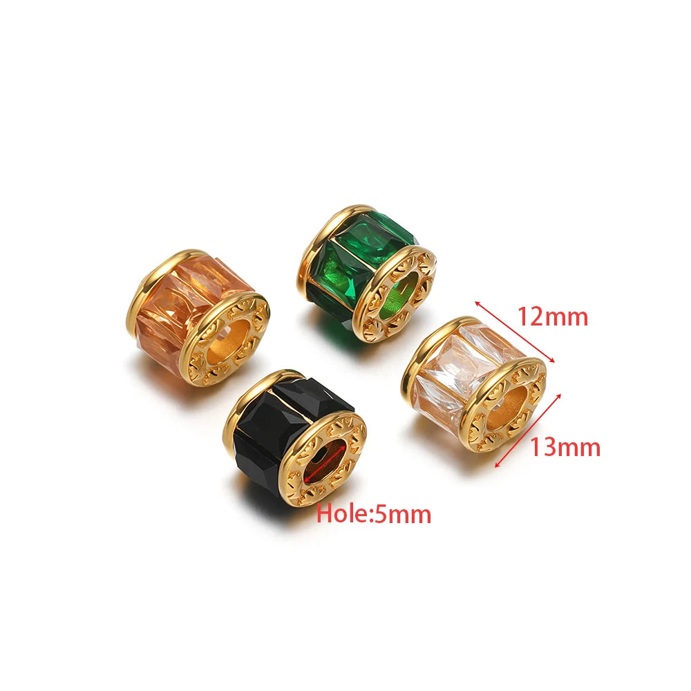Gold-plated spacer beads with green, orange, black, and clear-pink crystal insets