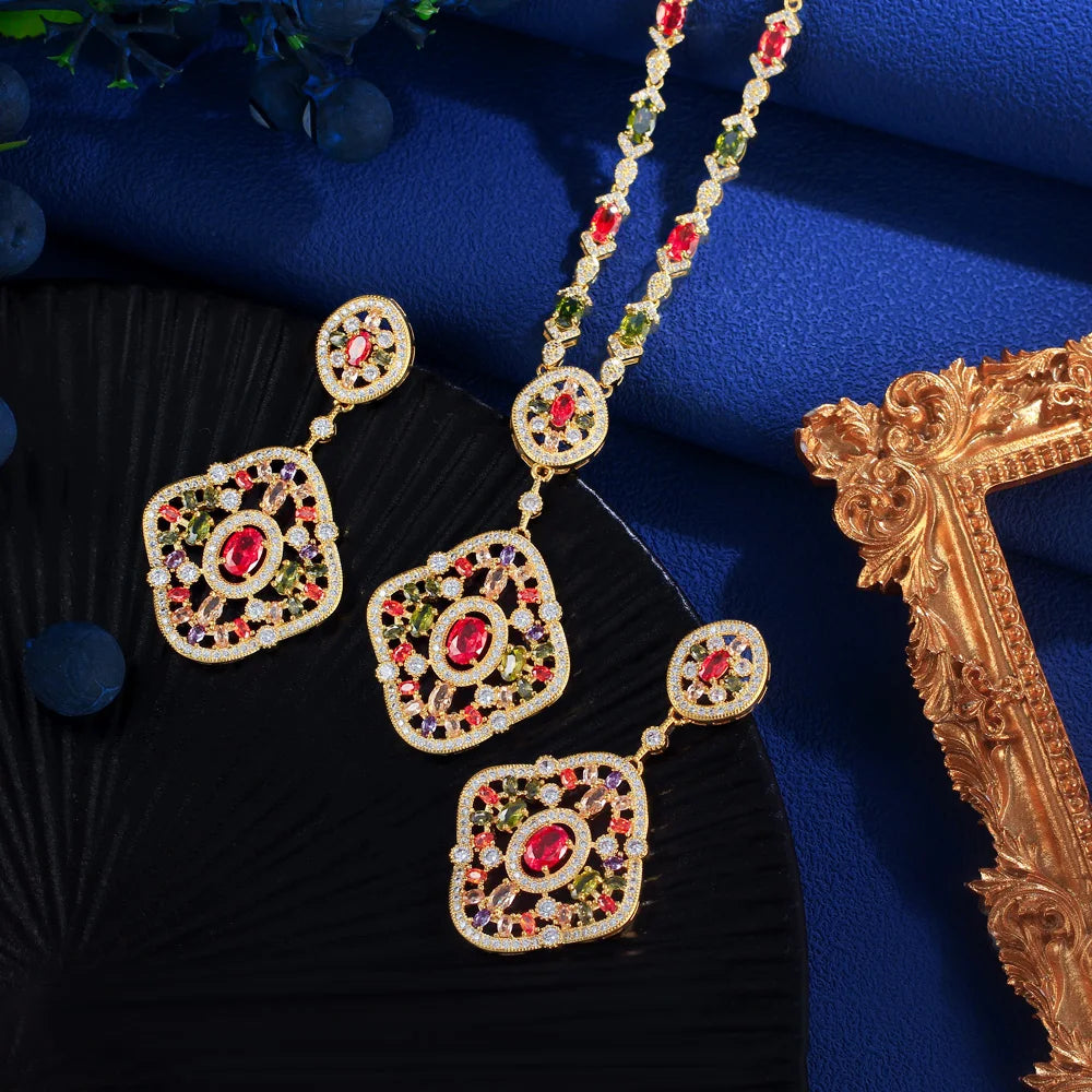 Gold-tone heart-shaped crystal drop earrings with long red and green necklace