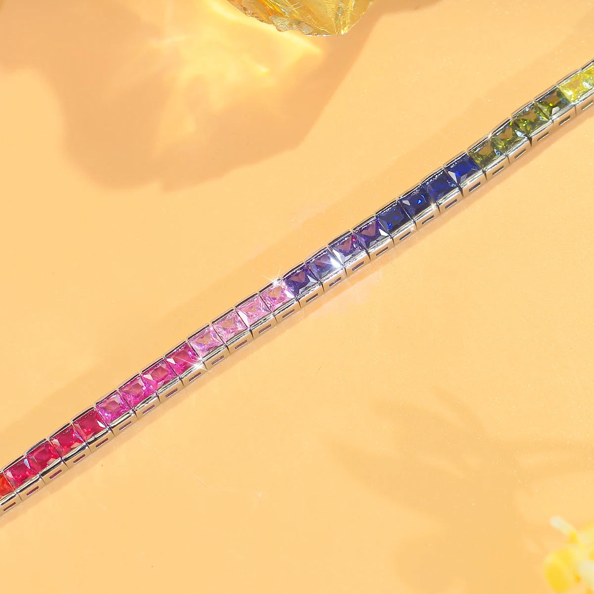 Close-up of square-cut rainbow zirconia stones set in a silver-tone bracelet