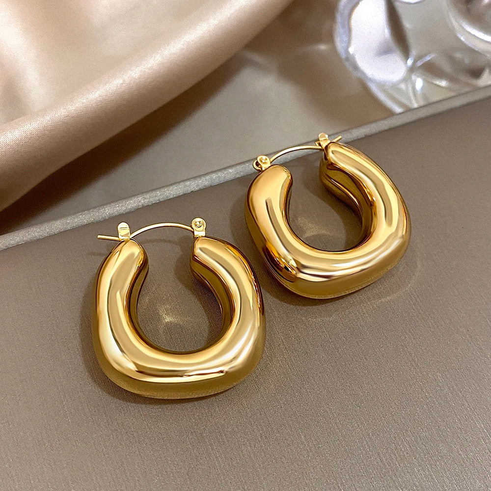 Pair of smooth, chunky U-shaped hoop earrings in a shiny gold tone