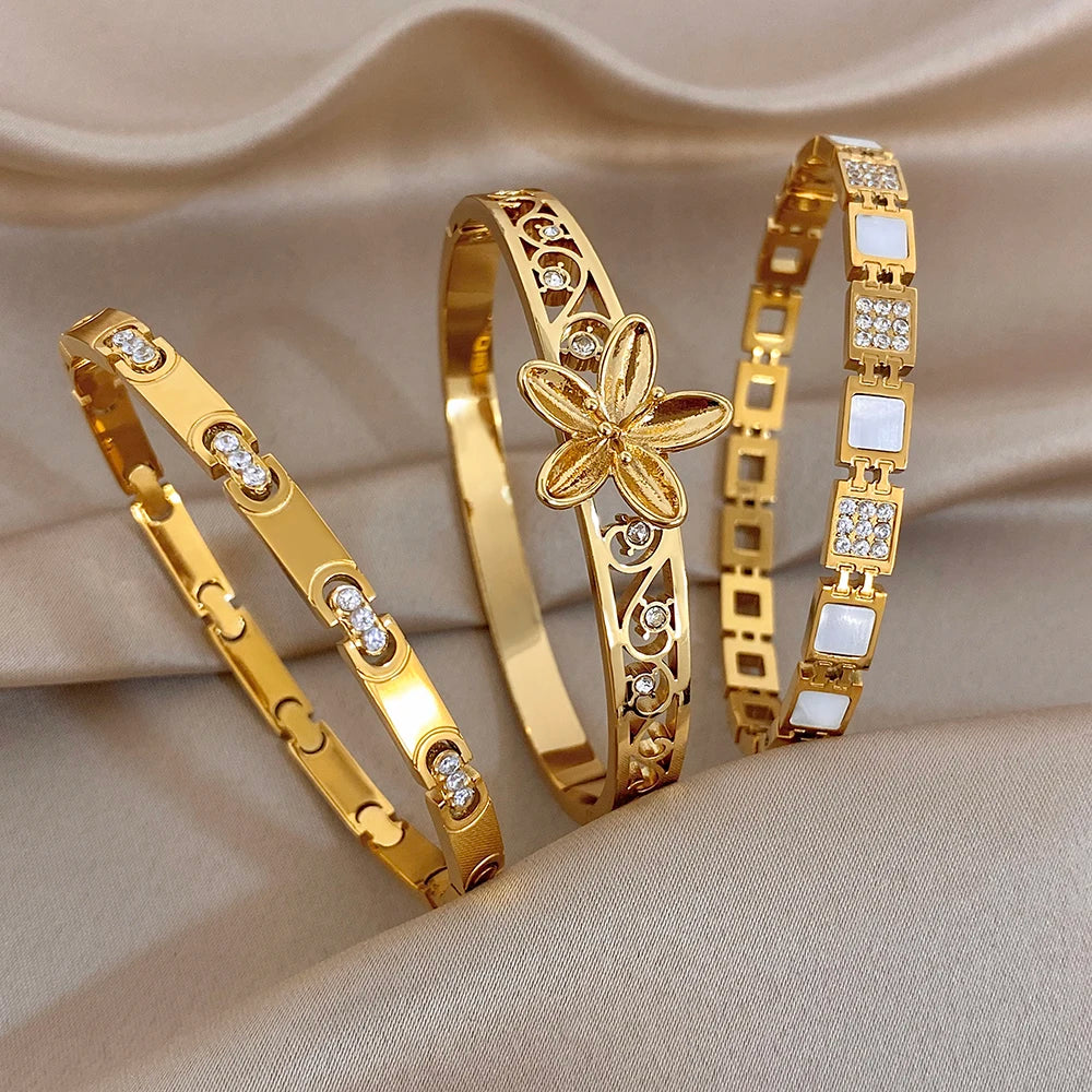 Gold-plated bangle set with hollow flower motifs and crystal accents, stacked cuffs