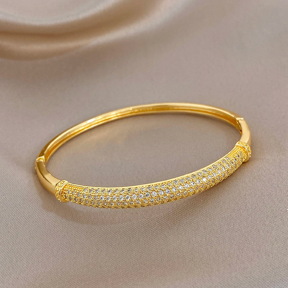 Gold-plated cuff bangle with clear zircon pave on the front