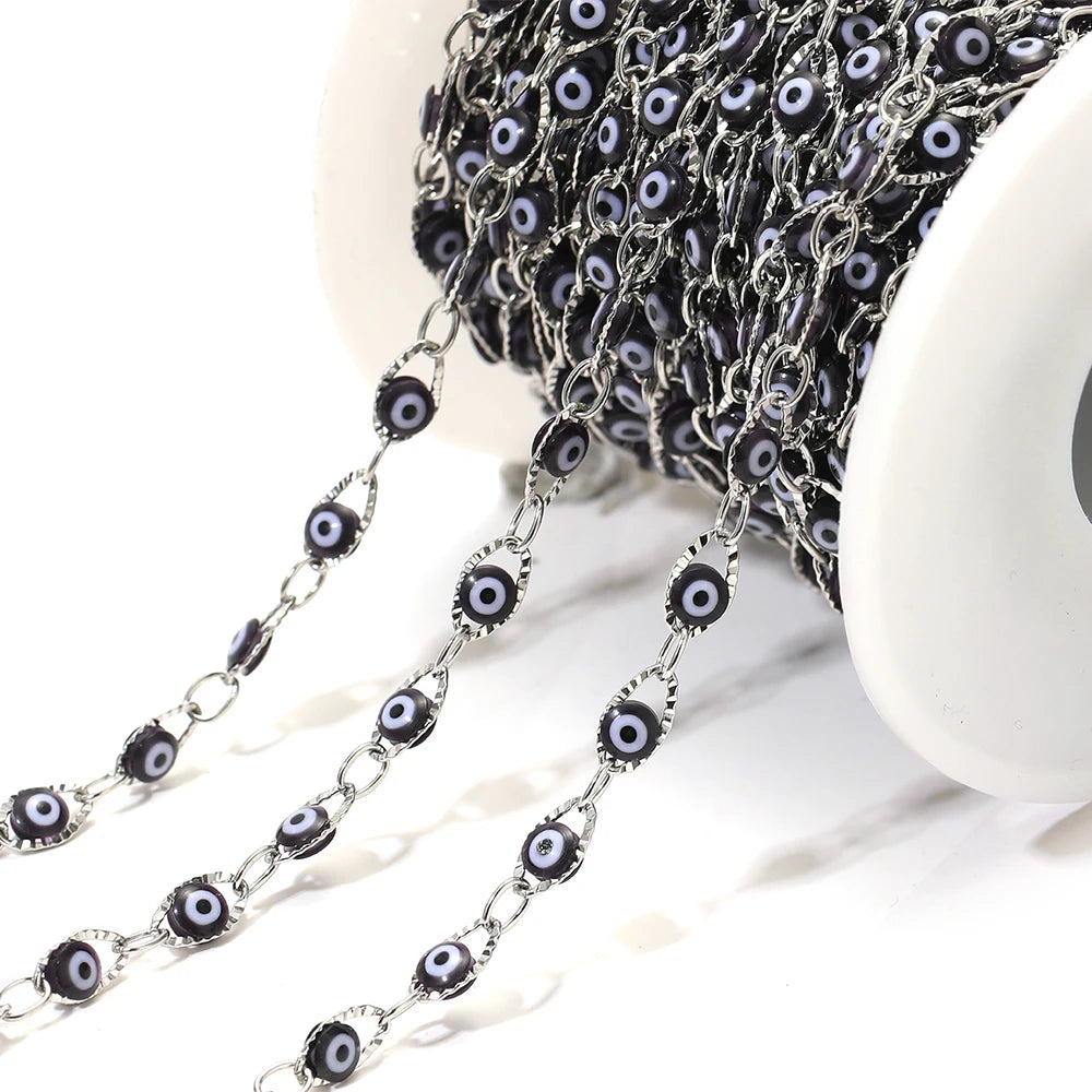 Dark evil eye bead chain with silver-tone links and black-and-blue oval eye beads