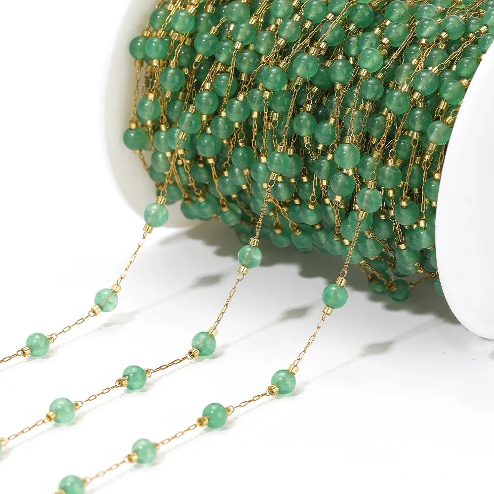 Turquoise bead strand on gold-tone chain, close-up view of repeating bead pattern