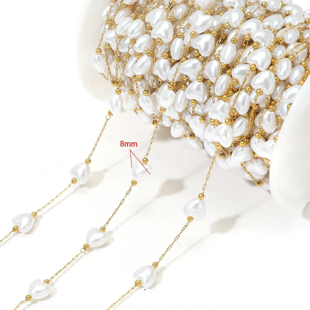 Artificial pearl chain with gold links and 8mm white oval beads