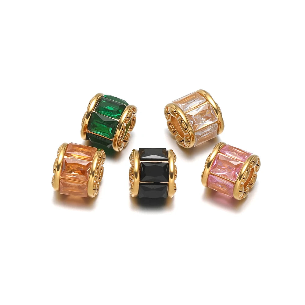 Gold-plated spacer beads with green, black, and peach crystal insets