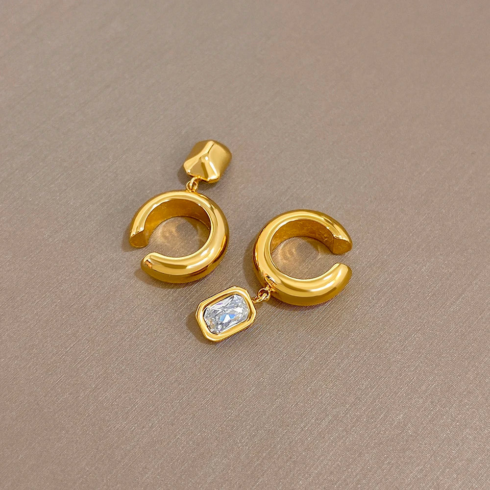 Gold-tone hoop ear clip earrings with small square zirconia dangling drops