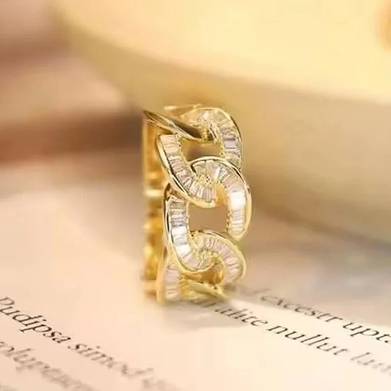 Gold-tone chain-link cubic zirconia ring with oval and round stones, close-up
