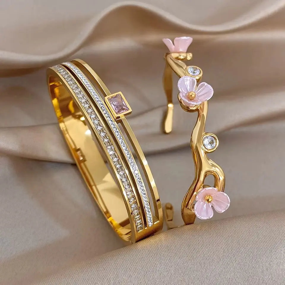 Gold-plated cuff bangle with pink flower and rhinestone accents, open flower branch detail