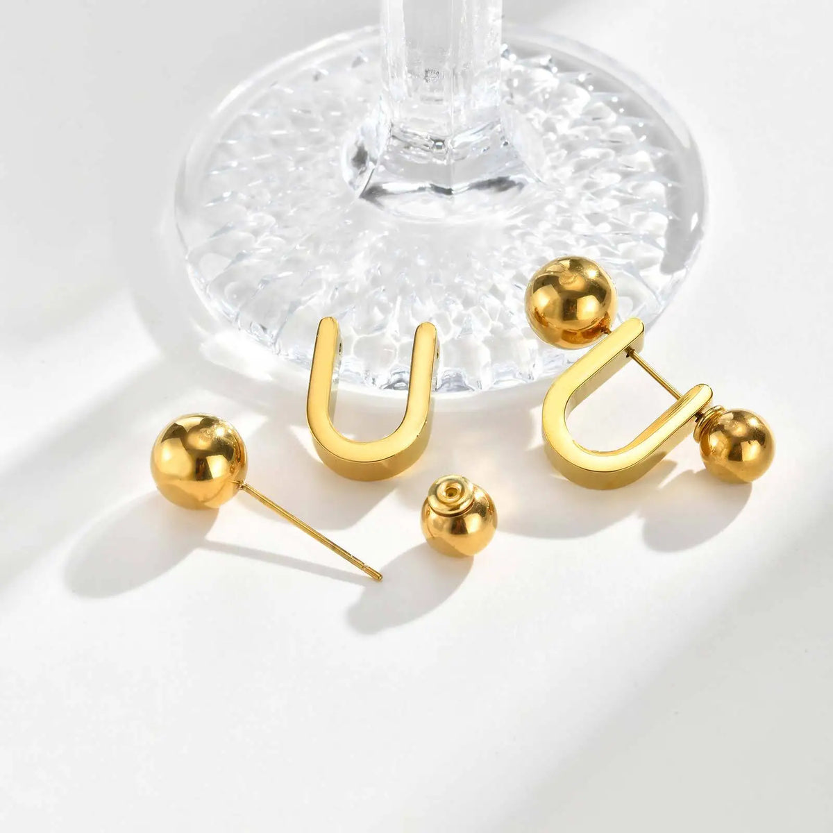 Gold U-shaped hoop earrings with round ball ends and post backs