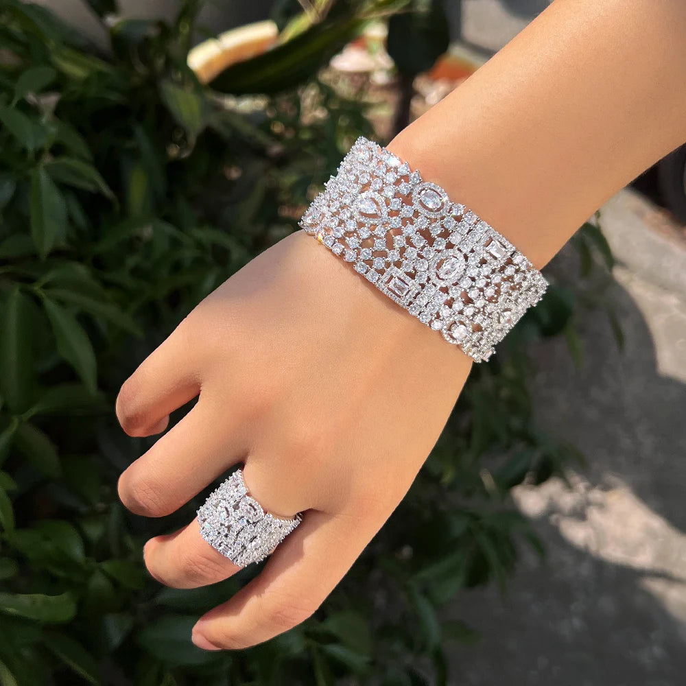 Silver-tone cubic zirconia cuff bracelet and wide matching ring worn on hand