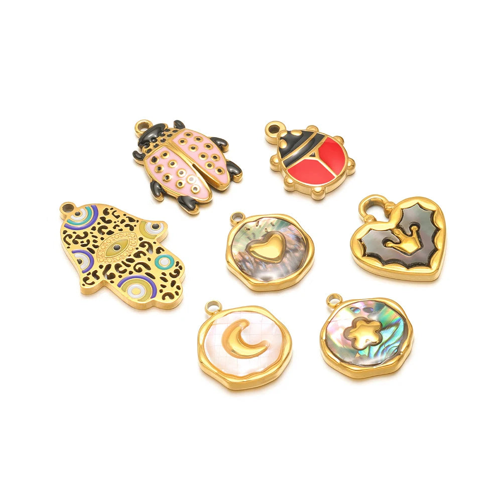 Set of beetle shell charm pendants in gold-tone with black, blue, red, and heart designs.