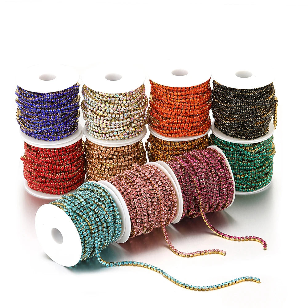 Multicolor rhinestone crystal chain tassel rolls on white spools, with dangling strands