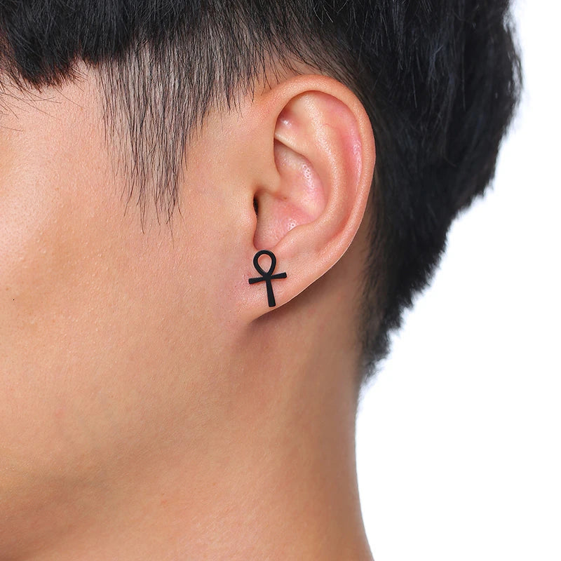 Black ankh cross stud earrings worn on ear
