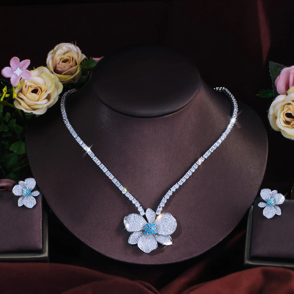Flower crystal necklace and matching stud earrings displayed on a jewelry bust