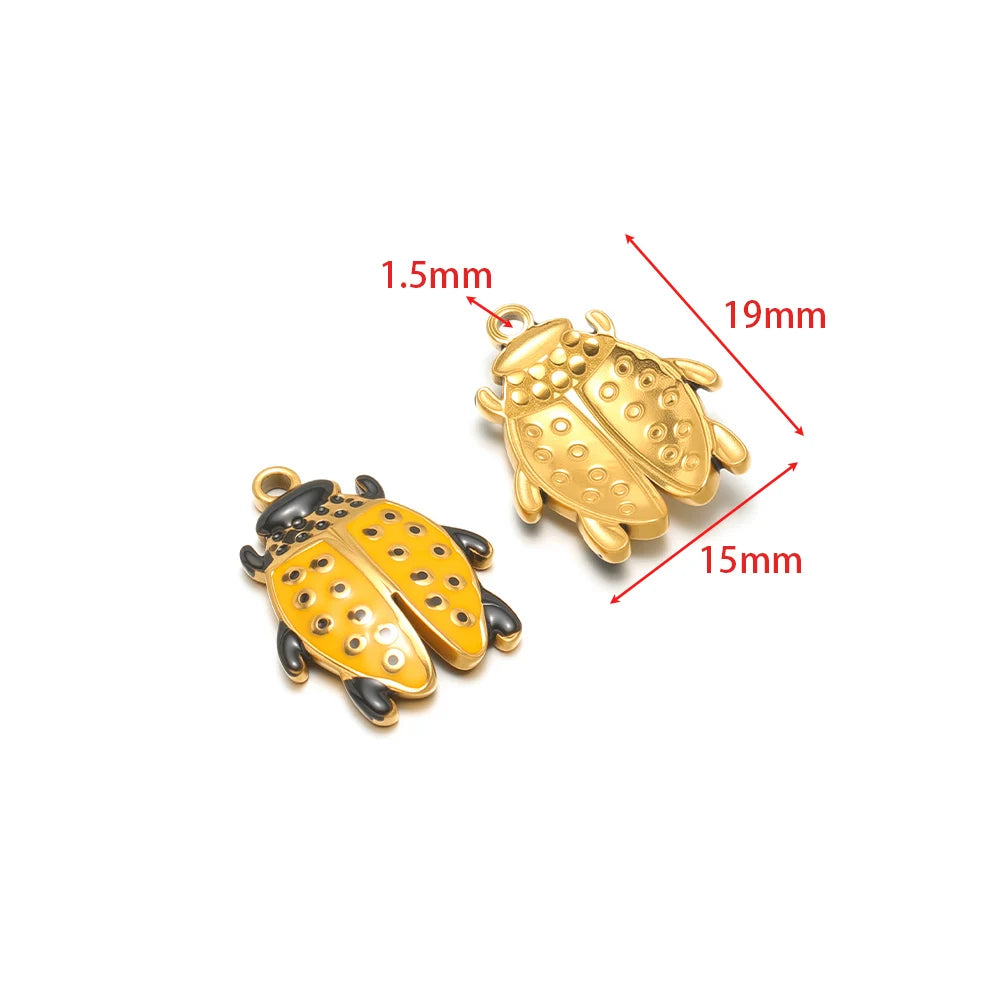 Gold and black beetle charm pendant with orange dot wing detail