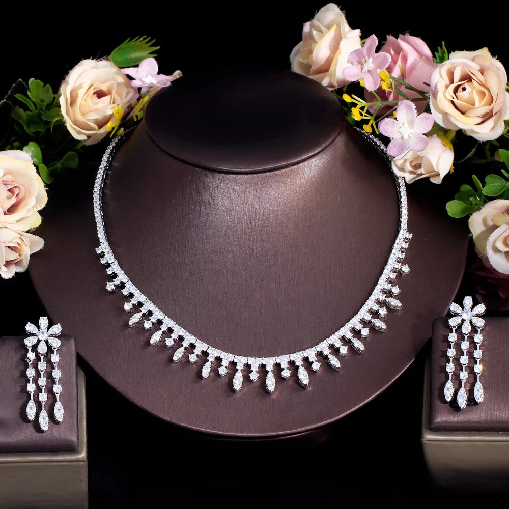 Sparkling cubic zirconia necklace with matching dangling earrings set on display bust