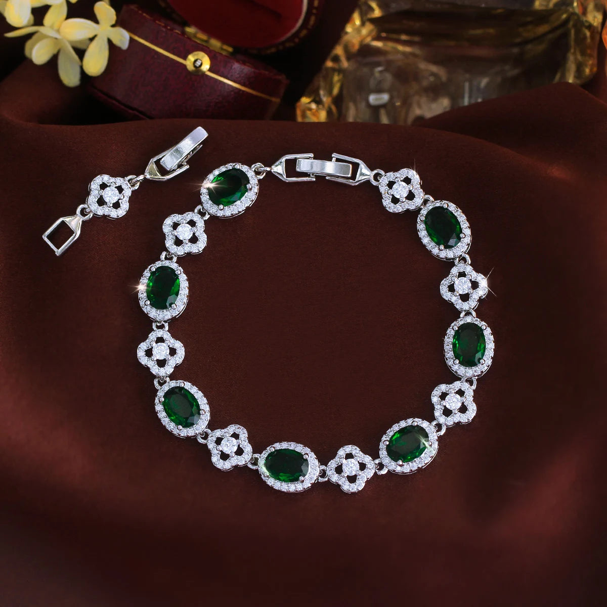 Green oval crystal flower tennis bracelet arranged in a circle with clasp