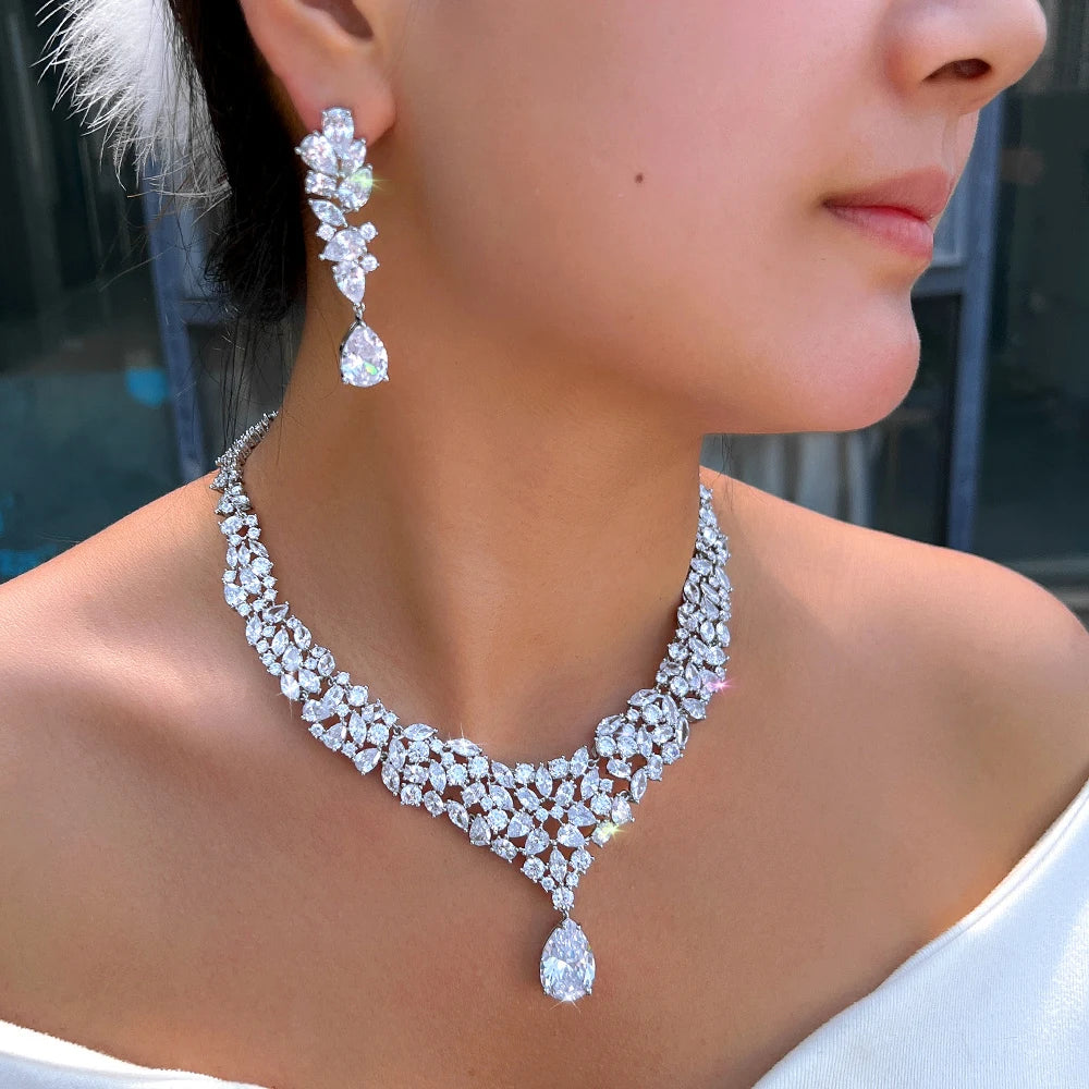 CZ necklace with a teardrop pendant and matching earring, shown worn