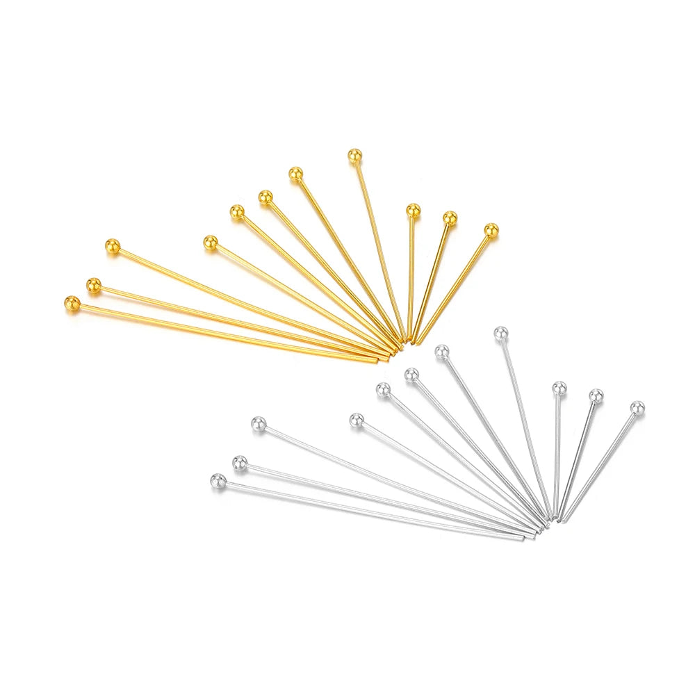 Grouped gold and silver T-eye pins with ball heads, straight shafts and loop eyes