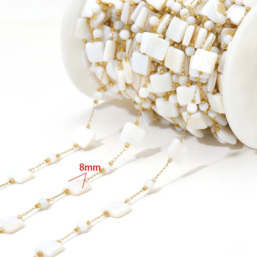 Shell bead jewelry chain with white shell cross pieces on gold-tone links (8mm marked)