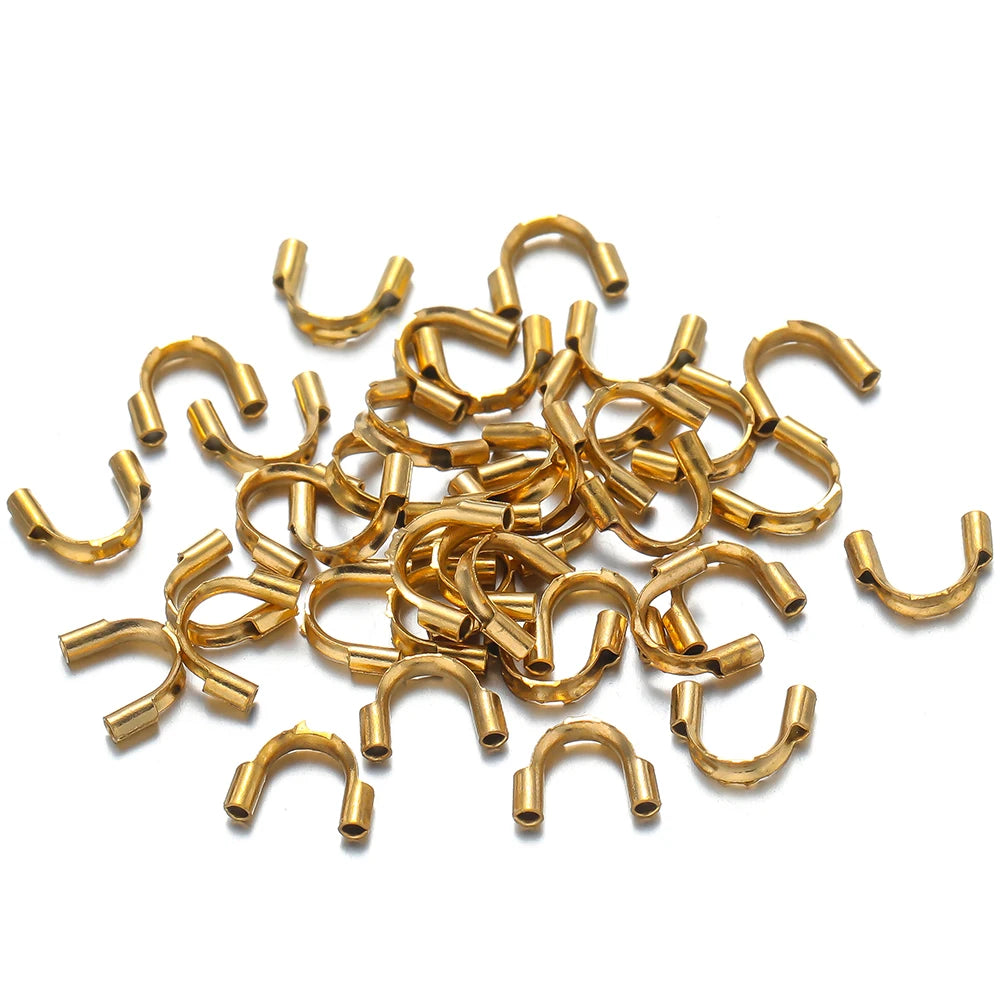 Gold U-shaped wire guard clasps, small connector pieces in a bundle