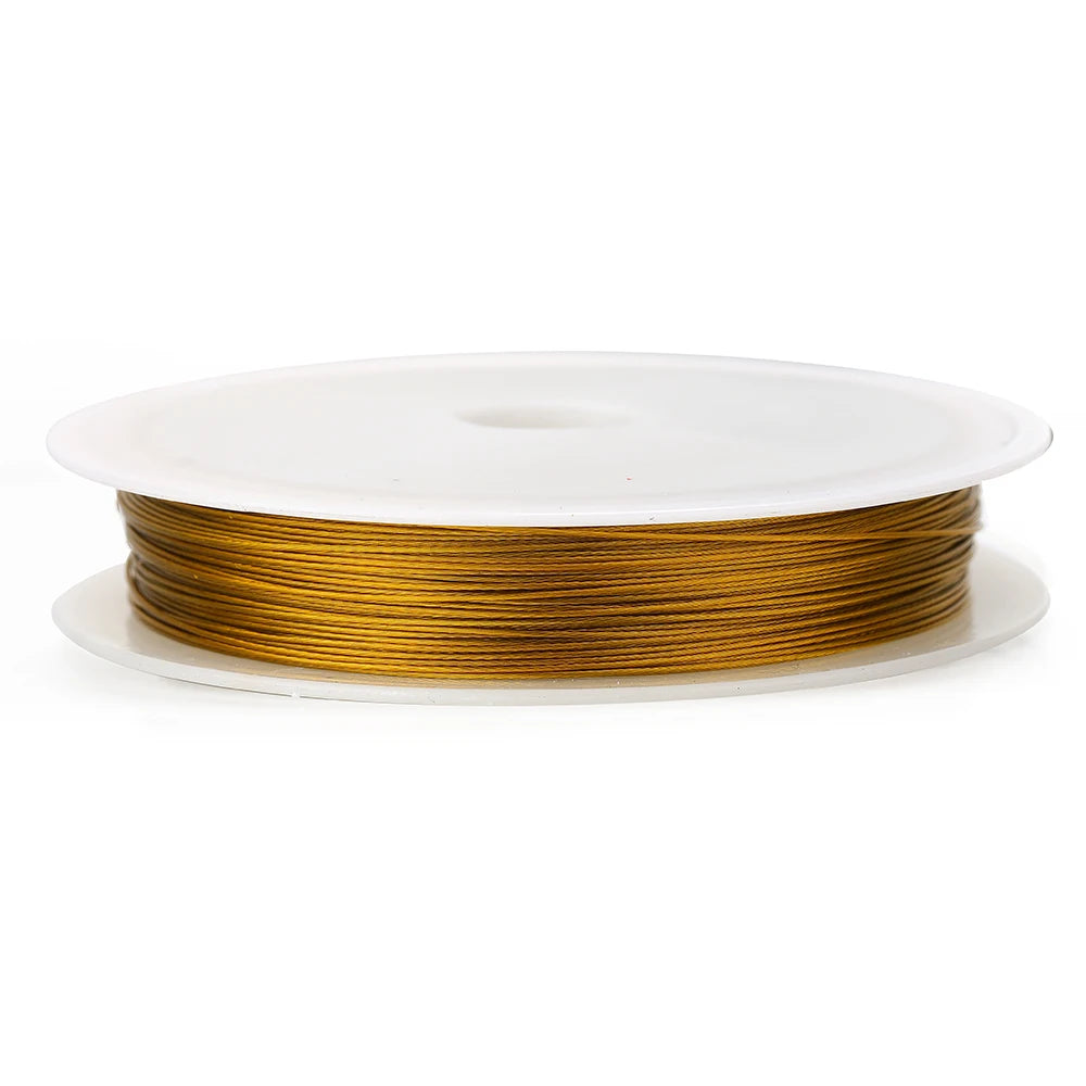 Gold stainless steel beading wire cord on a single white spool