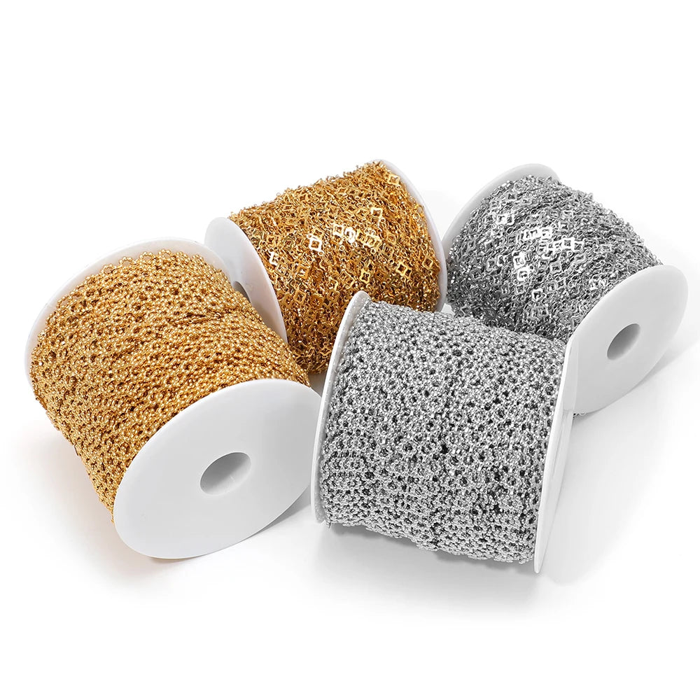 Gold and steel-toned square-link chains on three white spools for DIY bracelets