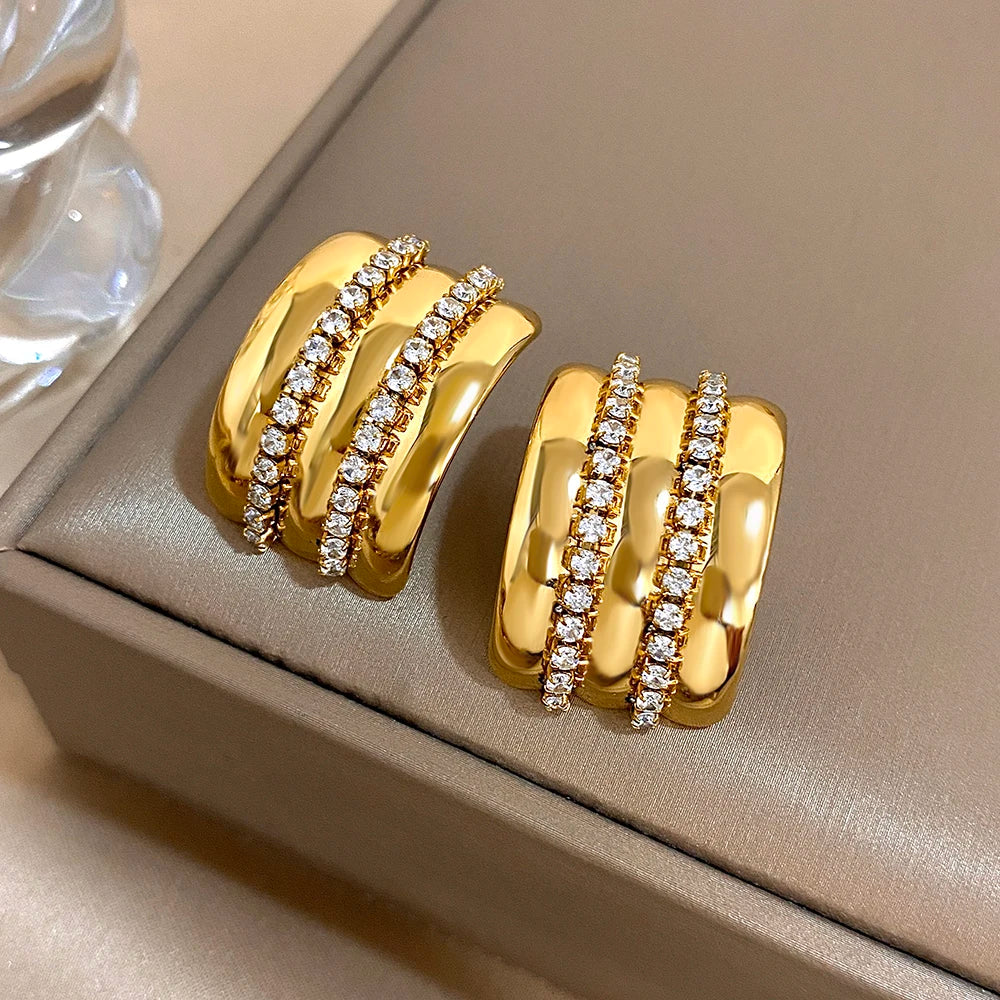 Pair of gold-tone rhinestone stud earrings shown at an angled view