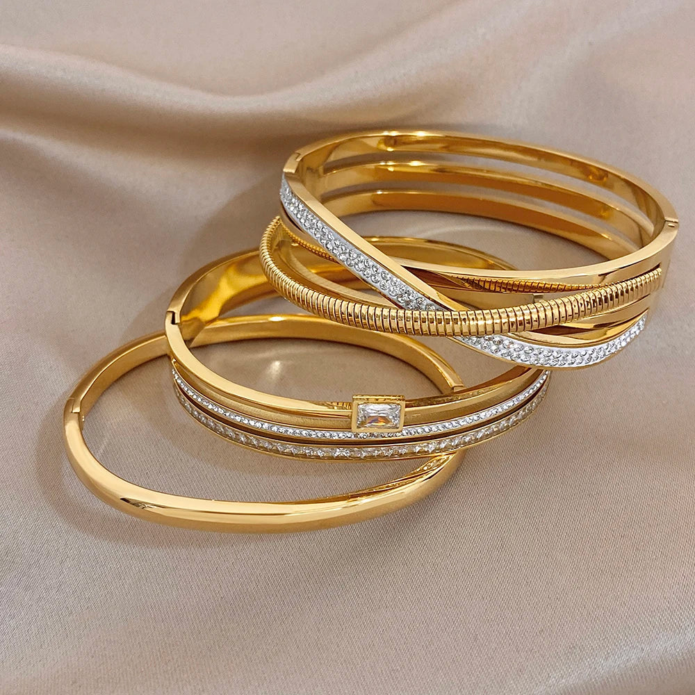 Gold-plated cuff bangle bracelets with clear stone accents, stacked design