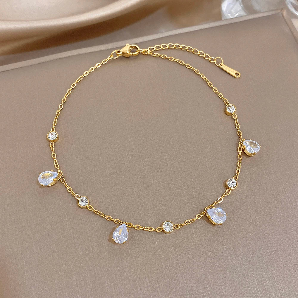 Gold-tone link bracelet with teardrop zircon accents and toggle clasp