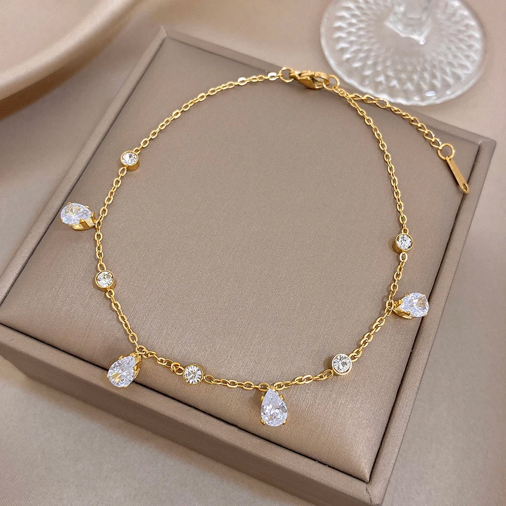 Gold-tone teardrop zircon link bracelet in jewelry box with toggle clasp