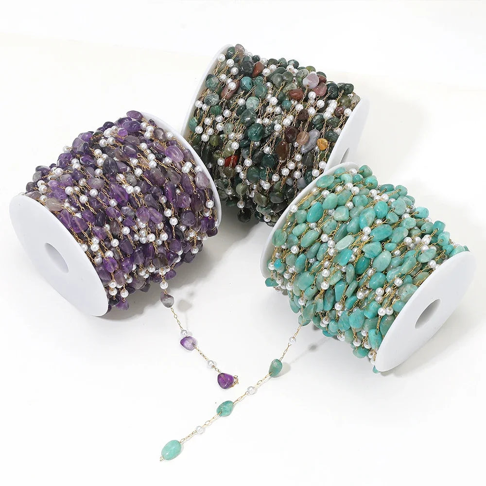 Irregular stone bead chain on gold-toned links with pearl accents, teal purple and green mix