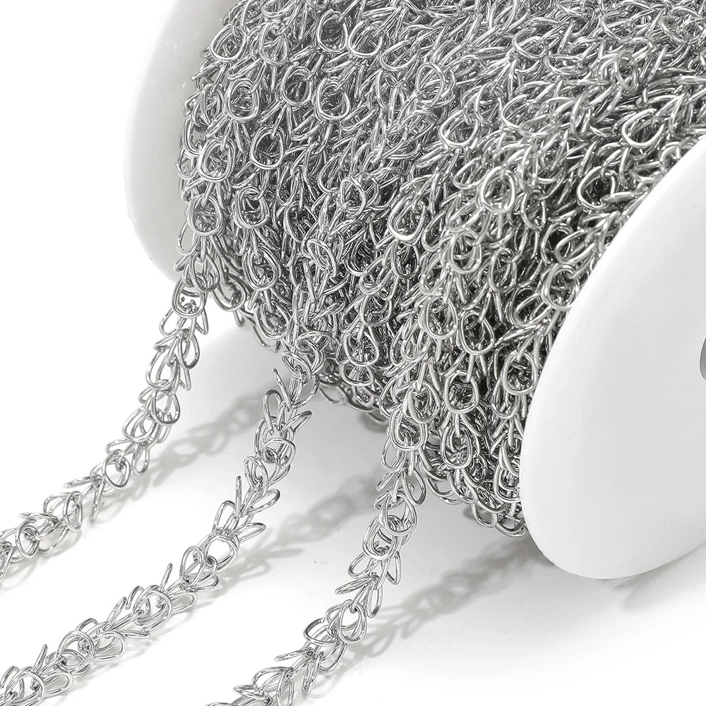 Close-up of silver spiral chain with teardrop-like flower swirl links