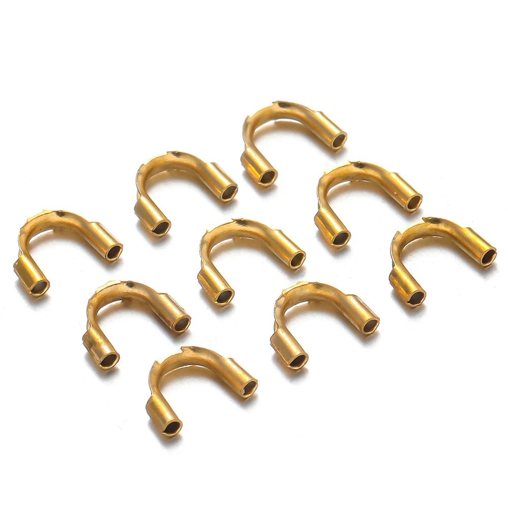 Gold U-shaped wire protector clasps, small connector pieces arranged together