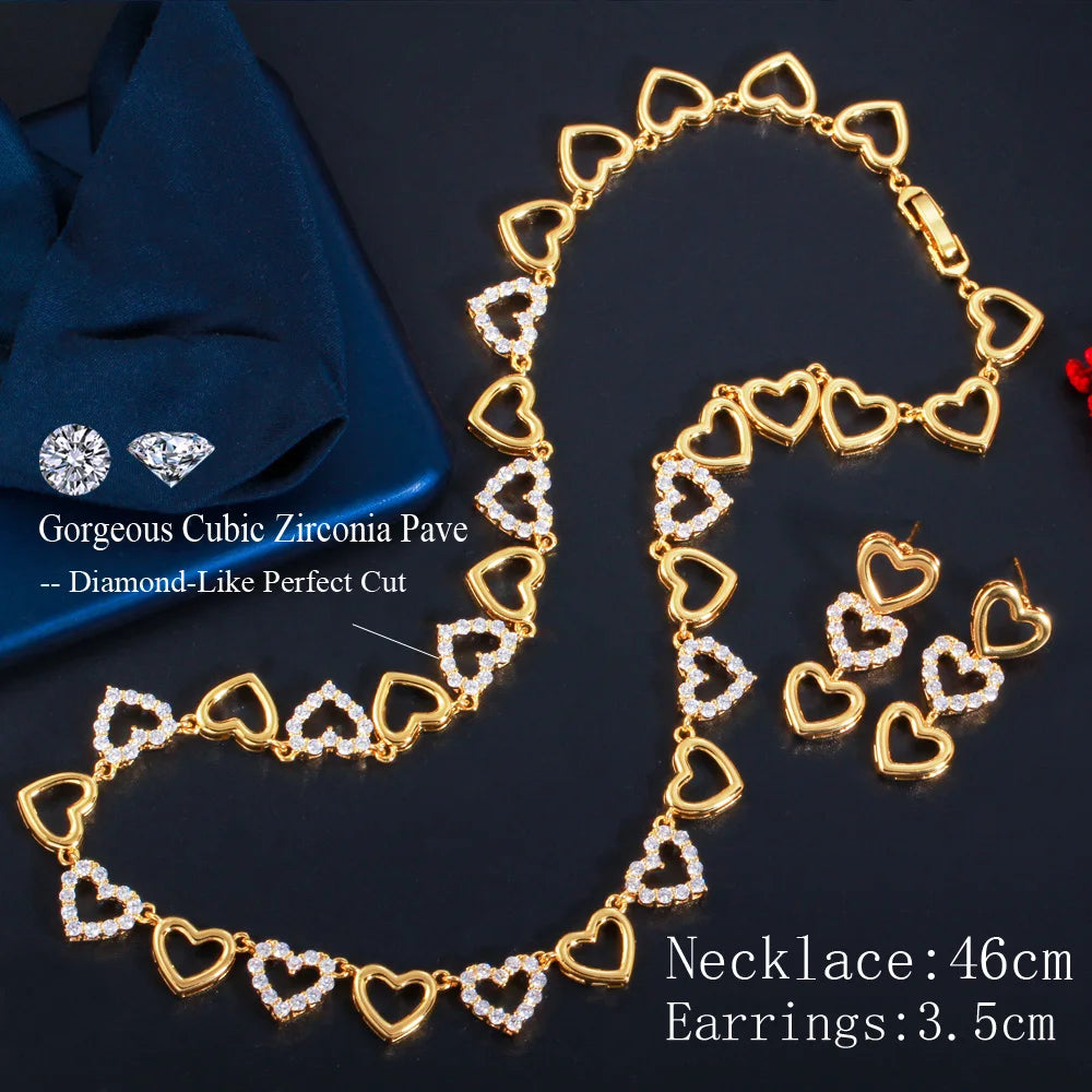 Gold-tone heart necklace and matching earrings with clear stones