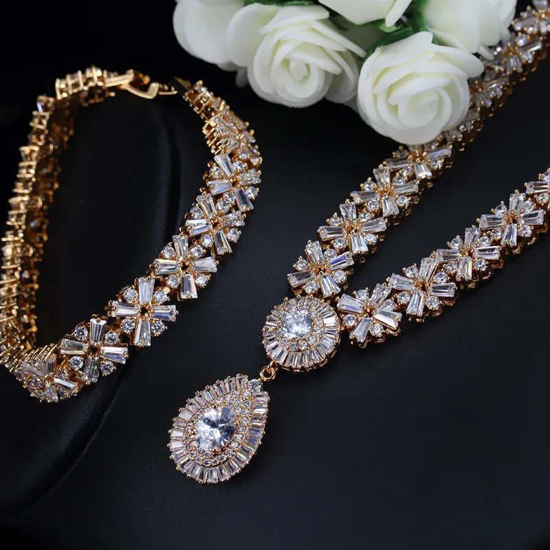 Gold-tone cubic zirconia necklace, bracelet, and drop earrings set with teardrop center stones