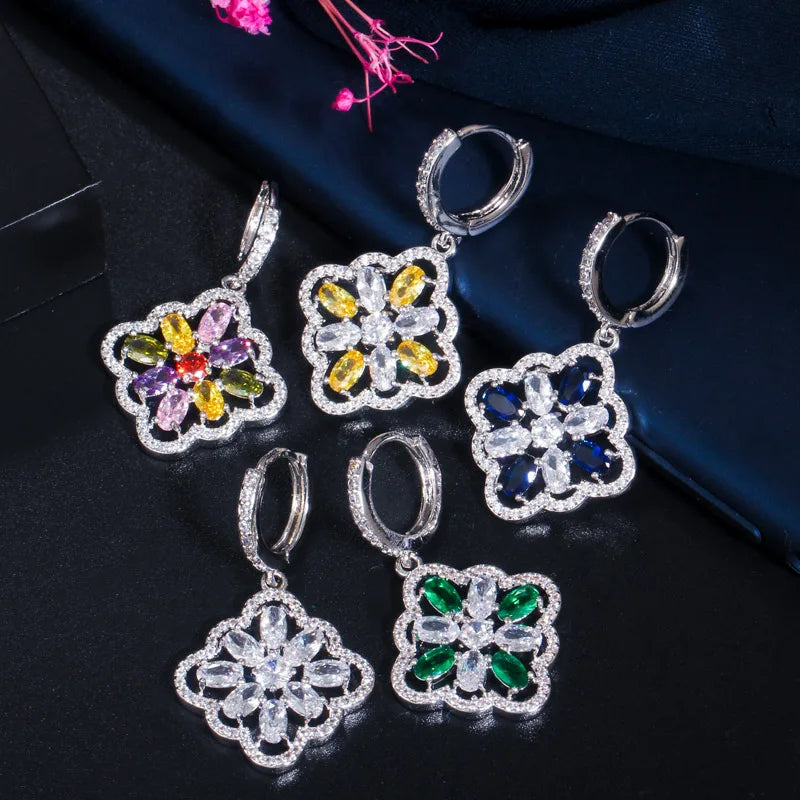 Five floral zircon drop earrings in clear, yellow, multicolor, blue, and green