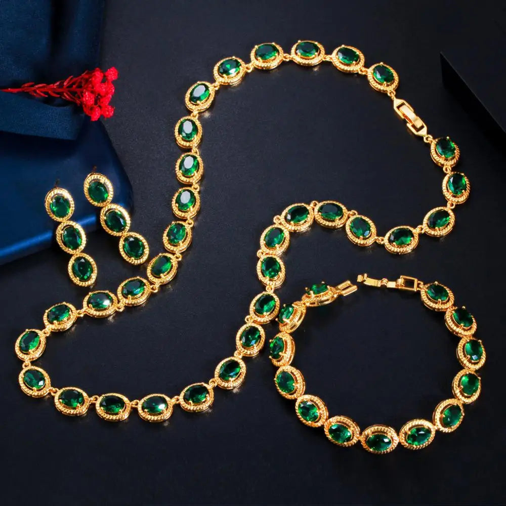 Gold-tone oval green zircon necklace and matching bracelet laid flat